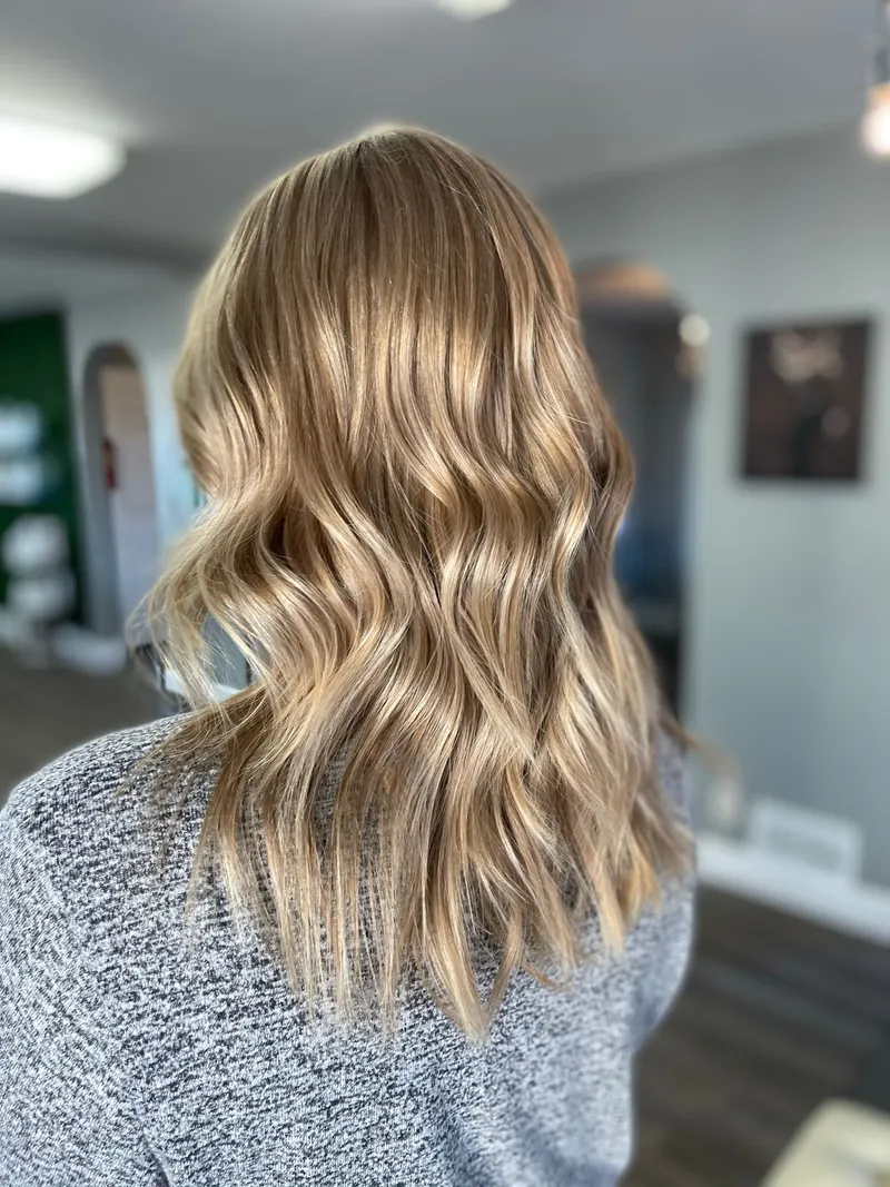 Dimensional lived-in blonde balayage with soft beach waves, by Stone Fox Salon in Meridian, Idaho