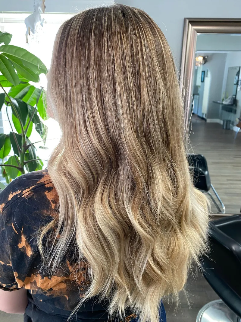 Lived-in blonde with a soft shadow root melting into bright blonde ends, by Stone Fox Salon in Meridian, Idaho